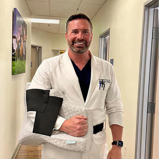 Person standing in a room with smile on his face