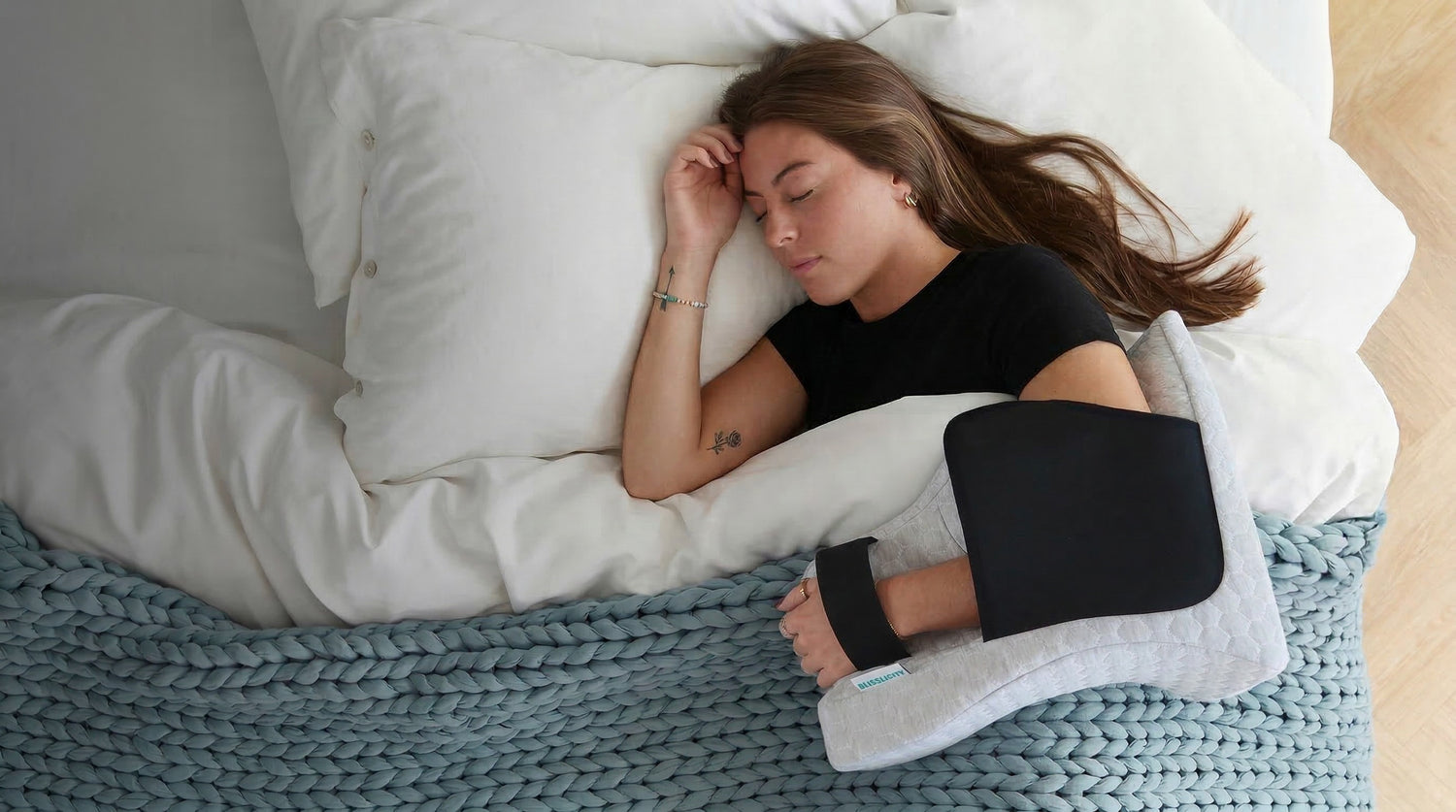 Women Sleeping on bed wearing shoulder sleeper pillow